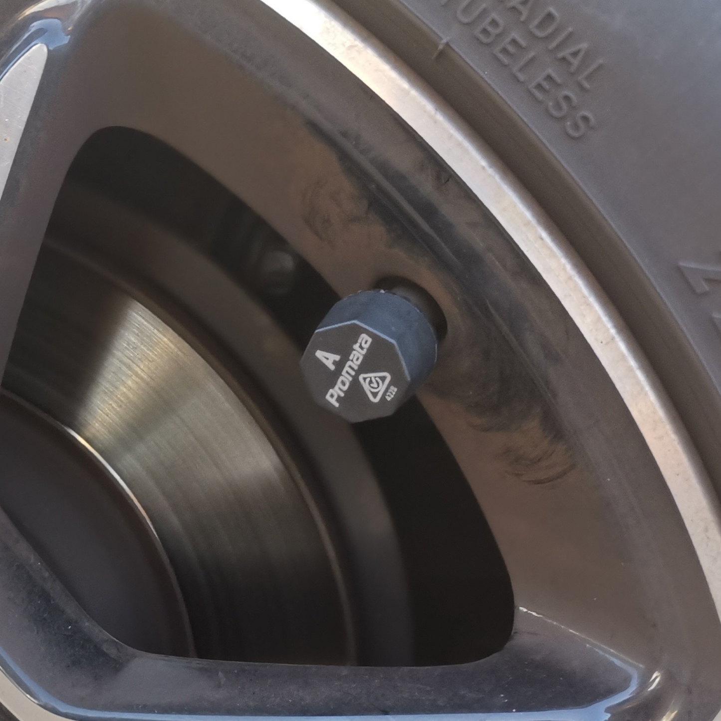Close-up of a Promata TPMS external sensor on tyre