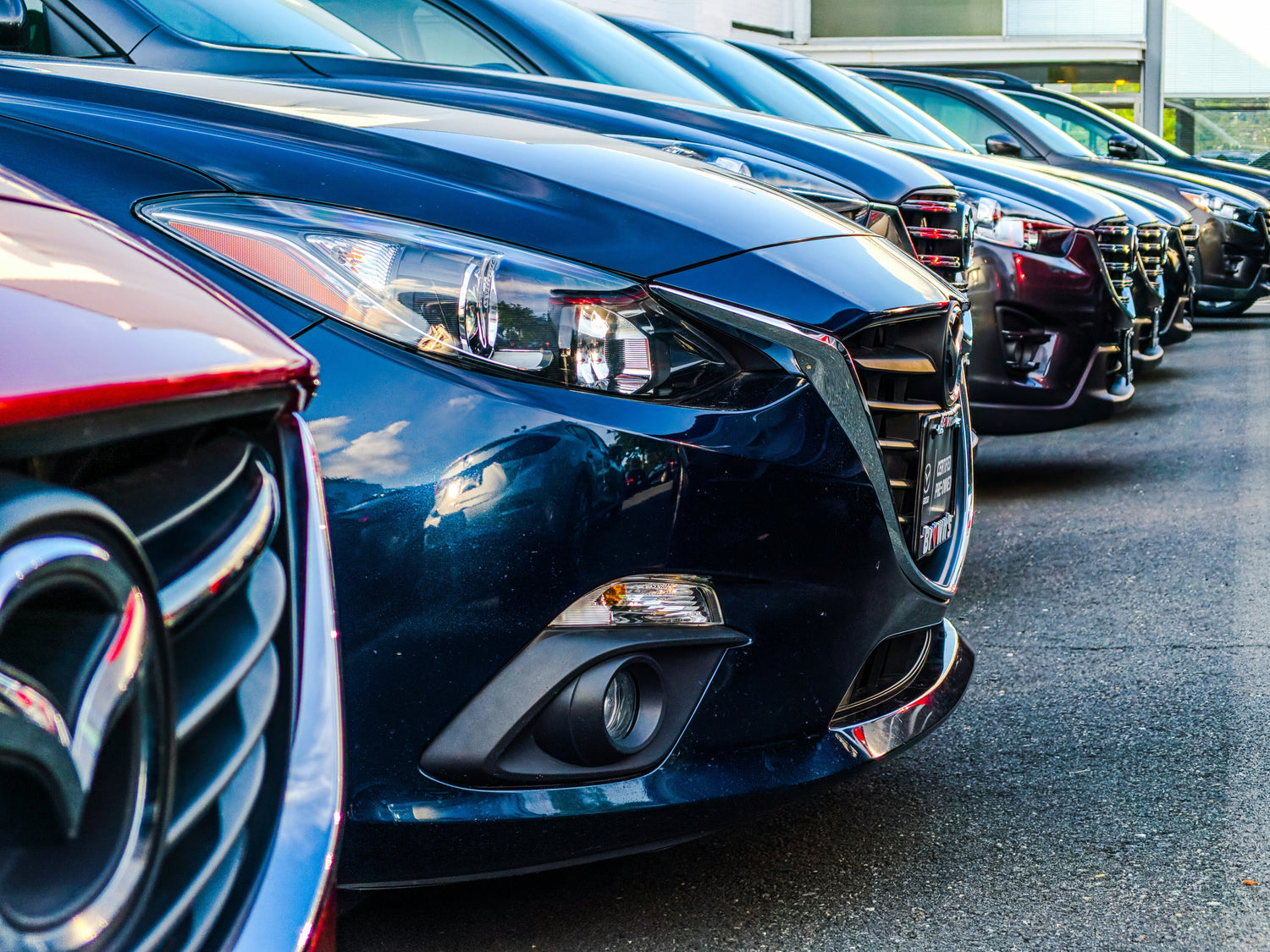 Close up image of the front of a car parked in a line
